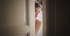 photo of woman behind door